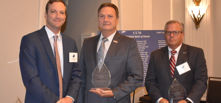 Jason Reibert (left), Chapter President of the Construction Management Association of America, presents awards to Sheriff Craig Webre (center) and Jim Brown (right), Director of Preconstruction Services at W.G. Yates & Sons Construction Company.