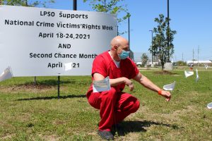 Inmate Brent Poiencot stops for a moment of reflection during the White Flag Exposition. 