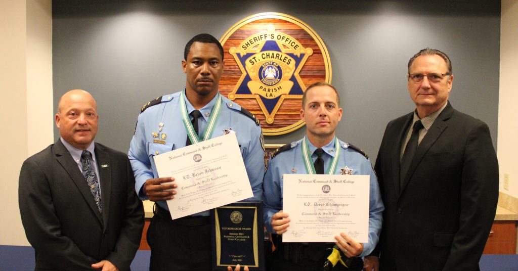 Graduates Lt. Kevin Johnson (left-center) and Lt. Derek Champagne (right-center) are pictured with LPSO Chief Deputy Roy Gros (far left) and Sheriff Craig Webre (far right).