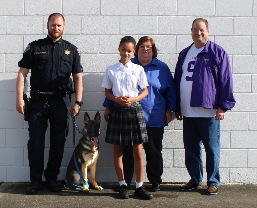 From left to right: Sergeant Charles Thomas, K-9 Athena, Joie Francise, Kathy Francise, and Jamie Francise. 